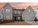 Inviting two-story home showcases white siding and a well-manicured front yard, captured at sunset at 2865 Ferncliff St, Cumming, GA 30028