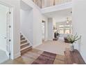 Spacious foyer features soaring ceilings, hardwood floors, staircase, and views into the living room at 2865 Ferncliff St, Cumming, GA 30028