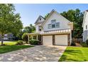 Beautiful home featuring a two-car garage and inviting front porch, set amidst lush landscaping at 301 Downing Creek Trl, Canton, GA 30114