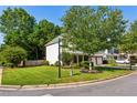 Well-maintained corner lot with lush lawn and mature trees framing a charming two-story home at 301 Downing Creek Trl, Canton, GA 30114