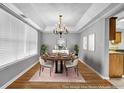 Elegant dining room with a chandelier, space for eight, and hardwood flooring at 4000 Crossings Way, Stone Mountain, GA 30083