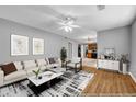 Comfortable living room with a fan, hardwood flooring, and neutral color scheme at 4000 Crossings Way, Stone Mountain, GA 30083
