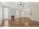 Bright and airy living room features a fireplace, arched windows, and beautiful hardwood floors at 4124 Berwick Farm Dr, Duluth, GA 30096