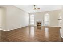 Spacious living room boasts a fireplace, large windows, and hardwood floors for an elegant touch at 4124 Berwick Farm Dr, Duluth, GA 30096
