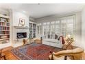 Bright living room with fireplace, built-in bookshelves, hardwood floors and many windows at 1717 N Decatur Ne Rd # 214, Atlanta, GA 30307