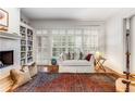 Comfortable living room with a fireplace, shelving, plantation shutters and an area rug at 1717 N Decatur Ne Rd # 214, Atlanta, GA 30307