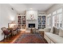 Cozy living room with a fireplace, built-in bookcases, hardwood floors and a vintage rug at 1717 N Decatur Ne Rd # 214, Atlanta, GA 30307