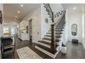 Elegant foyer with hardwood floors, staircase, and access to the kitchen and dining areas at 2360 Charleston Manor Ln, Suwanee, GA 30024