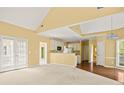 Open-concept living area with hardwood floors that connects to a kitchen and a door to the outside at 3187 Gainer Dr, Powder Springs, GA 30127