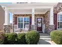 Inviting front porch with rocking chairs and stone accents for a cozy welcome at 496 Spring View Dr, Woodstock, GA 30188