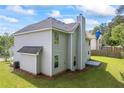 View of the backyard featuring a well maintained lawn and the rear of the home with neutral siding at 6895 Smoke Ridge Dr, Atlanta, GA 30349