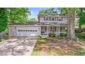 Attractive home with a two-car garage, and covered front porch enhanced by mature trees and landscaping at 15 Ashton Pl, Covington, GA 30016