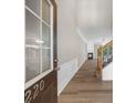 Bright entryway featuring sleek floors, wainscoting and a staircase at 220 Finchley Dr, Roswell, GA 30076