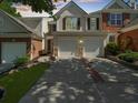 Inviting townhome with a well-manicured lawn and a two-car garage at 220 Finchley Dr, Roswell, GA 30076