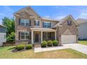 Attractive two-story brick home with a well-kept lawn, attached garage, and inviting curb appeal at 5465 Mirror Lake Dr, Cumming, GA 30028