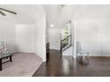 Bright living room featuring hardwood floors, white walls, and staircase at 5465 Mirror Lake Dr, Cumming, GA 30028