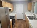 Kitchen featuring stainless steel appliances, wood cabinets, and white countertops at 1103 Waldrop Pl, Decatur, GA 30034