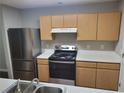 Kitchen featuring stainless steel appliances, wood cabinets, and white countertops at 1103 Waldrop Pl, Decatur, GA 30034
