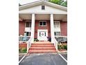 Inviting building entrance featuring a white door with wreath and brick stairs at 135 E Hill St # 12, Decatur, GA 30030