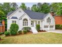 Charming two-story painted brick home featuring a well-manicured front yard, symmetrical design, and a two-car garage at 1730 Point Pleasant Se, Smyrna, GA 30080
