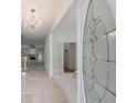 Elegant foyer featuring marble flooring, a decorative chandelier, and a view into a bright living room with a fireplace at 1730 Point Pleasant Se, Smyrna, GA 30080