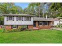Charming split-level home with brick accents and a lush green lawn at 2757 Shelley Ln, Ellenwood, GA 30294