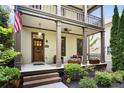Inviting front porch with seating, landscaping, and a decorative door that enhances curb appeal at 5160 Pratt Sw St, Covington, GA 30014
