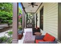 Inviting front porch with comfortable seating, a ceiling fan, and views of lush landscaping at 5160 Pratt Sw St, Covington, GA 30014