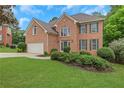 Attractive brick home with a well-maintained lawn and mature landscaping, perfect curb appeal at 5435 Vicarage Walk, Alpharetta, GA 30005