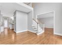 Spacious home foyer with hardwood floors, staircase, and natural light showcasing a welcoming atmosphere at 5435 Vicarage Walk, Alpharetta, GA 30005