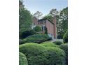 Beautiful brick home with a two car garage and mature landscaping at 990 Azalea Dr, Roswell, GA 30075