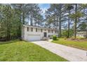 Charming two-story home featuring a classic brick facade, attached garage, and a well-maintained front yard at 6307 Thornhedge Dr, Riverdale, GA 30296
