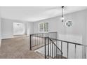 Bright living room featuring neutral paint, cozy carpet, and large windows offering ample natural light at 6307 Thornhedge Dr, Riverdale, GA 30296