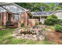 A charming backyard featuring a decorative pond, lush greenery, and a swing at 801 Sugar Creek Se Trl, Conyers, GA 30094
