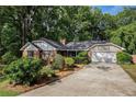 Charming brick home with a well-maintained lawn, mature landscaping, and a two-car garage at 801 Sugar Creek Se Trl, Conyers, GA 30094
