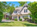 Charming two-story home with a well-manicured lawn and lush landscaping enhancing its curb appeal at 1028 Amsterdam Ne Ave, Atlanta, GA 30306