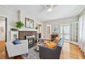 Inviting living room with hardwood floors, fireplace, and an open doorway to an enclosed sunroom at 1028 Amsterdam Ne Ave, Atlanta, GA 30306