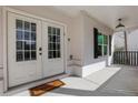 Close-up of the covered front porch showcasing a stylish front door, brickwork and a welcoming welcome mat at 2383 Colonial Ne Dr, Brookhaven, GA 30319