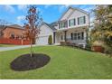 Charming two-story home featuring a manicured lawn and classic design elements with a mulched planting bed at 2383 Colonial Ne Dr, Brookhaven, GA 30319