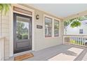 Inviting front porch with gray flooring, a black front door, and classic architectural details at 301 Fortune Ne St, Atlanta, GA 30312