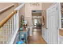 Inviting foyer featuring hardwood floors, decorative accents, and a view into the dining room at 5077 Newpark Nw Dr, Acworth, GA 30101
