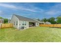 Spacious, well-maintained backyard with a fenced perimeter, lush grass, and a covered patio at 5344 Flat Rock Pt, Stonecrest, GA 30038