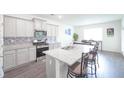 Modern kitchen featuring stainless steel appliances, granite countertops, and a breakfast bar at 5344 Flat Rock Pt, Stonecrest, GA 30038