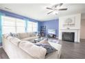 Cozy living room with a fireplace, hardwood floors, and ample natural light from large windows at 5344 Flat Rock Pt, Stonecrest, GA 30038