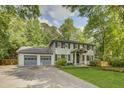 Charming two-story home with a two-car garage, showcasing a well-maintained front yard at 1615 Arden Sw Dr, Marietta, GA 30008