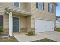 Inviting front entrance with a well-maintained lawn, and a two-car garage at 33 Oxford Ln, Kingston, GA 30145
