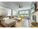 Bright living room features a large sectional, fireplace, and hardwood floors at 155 Marlow Dr, Woodstock, GA 30188