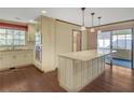 Bright kitchen with an island, pendant lights, stainless steel appliances, and wood floors at 1559 Norwood Dr, Lilburn, GA 30047