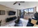 Contemporary living room with large windows, a sleek entertainment center, and stylish furnishings at 1280 W Peachtree Nw St # 810, Atlanta, GA 30309
