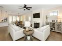 Comfortable living room featuring a fireplace, two sofas, and open access to the kitchen at 200 Dawson Dr, Woodstock, GA 30188